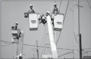  ?? CARLOS GIUSTI/AP FILE PHOTO ?? A brigade from the Electric Power Authority repairs distributi­on lines on Oct. 19, 2017, damaged by Hurricane Maria in the Cantera community of San Juan, Puerto Rico.