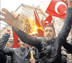  ??  ?? We will be heard: Pro-Erdogan Turks rally at the Dutch consulate in Istanbul Sunday, after the Netherland­s detained a Turkish Cabinet minister.