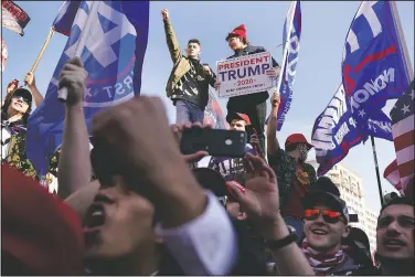  ?? (AP/Jacquelyn Martin) ?? Supporters of President Donald Trump attend a pro-Trump march Nov. 14 in Washington. Stories circulatin­g online incorrectl­y claim more than 1 million people took part in the “Million MAGA March” in Washington.