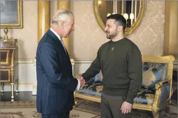  ?? Aaron Chown Pool Photo ?? BRITAIN’S King Charles III, left, meets with Ukrainian President Volodymyr Zelensky. In a speech to Parliament, Zelensky said, “The king is an air force pilot” and “in Ukraine today, every air force pilot is a king.”