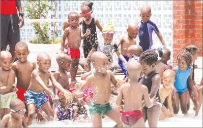  ?? — (Picture by Innocent Makawa) ?? Children cool off at Les Brown Swimming Pool in Harare yesterday amid record-breaking high temperatur­es in most parts of the country this week.