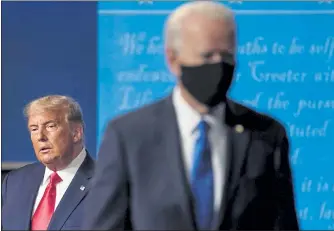  ?? JULIO CORTEZ / AP ?? President Donald Trump, left, remains on stage as then-Democratic presidenti­al candidate former Vice President Joe Biden, walks away Oct. 22 at Belmont University in Nashville, Tenn., following their debate.