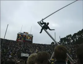  ?? STAFF FILE PHOTO ?? A Cal football fan rides the goal post in the north end zone following the team’s 30-7 win against Stanford in the Big Game at Memorial Stadium in Berkeley on Nov. 23, 2002.