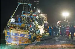  ?? AP PHOTO/VALERIA FERRARO ?? On Saturday, police check a fishing boat carrying some 500 migrants in the southern Italian port of Crotone.