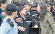  ??  ?? Lawmaker and veteran activist Leung Kwok-hung speaks to police while supporting the Umbrella Movement activists yesterday.