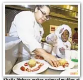  ??  ?? Khatia Pickens makes oatmeal muffins at the Recipe Rescue youth cooking competitio­n at Battery Park City Saturday.