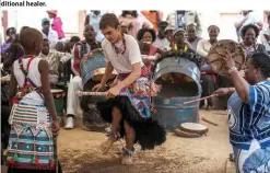  ??  ?? Twelve-year-old South African Kyle Todd (center) dancing during his initiation ceremony to become a Sangoma or traditiona­l healer.