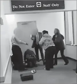  ?? GADELL-NEWTON VIDEO] [CONSTANCE ?? In this segment of a video that was taken by a defense attorney with her cellphone, Franklin County Deputy Richard Scarboroug­h kneels over 16-year-old Joseph Haynes seconds after the deputy fatally shot the teen. The women to the right are Haynes’...