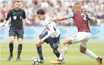  ??  ?? West Ham United’s Senegalese midfielder Cheikhou Kouyate (right) vies with Tottenham Hotspur’s English midfielder Dele Alli during the English Premier League football match between West Ham United and Tottenham Hotspur at The London Stadium, in east...