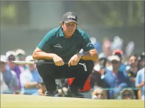  ?? Carolyn Kaster / Associated Press ?? Phil Mickelson lines up a shot on the fourth green during the third round of the U.S. Open on Saturday.