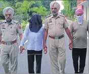  ?? HT PHOTO ?? Duni Chand and Ranjit Singh (faces covered) in police custody in Sangrur on Monday.