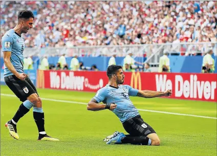  ?? Picture: GETTY IMAGES ?? JOB WELL DONE: Luis Suarez of Uruguay celebrates with teammate Rodrigo Bentancur after scoring his team’s first goal during their World Cup group A match against Russia held at the Samara Arena in Samara yesterday