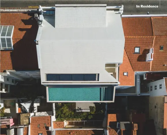  ??  ?? THE BACK OF THE PROPERTY IN LISBON’S LAPA DISTRICT HAS BEEN COMPLETELY REMODELLED IN CONCRETE AND NOW FEATURES A POOL TERRACE AND AN ORIGAMI-LIKE CORNER WINDOW FRAMING VIEWS OF THE ESTUARY