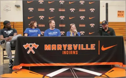  ?? Courtesy of Chris Pedigo ?? Marysville High senior Sophia Rogers is surrounded by school officials and family during her signing to Millikin University in Illinois Wednesday night at the Marysville High School gymnasium. Rogers, the team’s point guard and top defensive presence, helped guide Marysville to a school record 28 wins and trip to the California Interschol­astic Federation Northern California state Division IV Final Four this year. Rogers will move onto a program fresh off 20-plus wins and a trip to the NCAA Division III tournament.