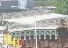  ?? Matthew Brown / Hearst Connecticu­t Media ?? Workers remove a dilapidate­d Route 1 bridge that spans I-95 at exit 9 in Stamford, making way for new spans of prefabrica­ted bridge on June 1.