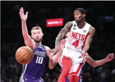  ?? (AP photo/Frank Franklin II) ?? Brooklyn Nets’ Edmond Sumner (4) passes the ball away from Sacramento Kings’ Domantas Sabonis (10) Thursday during the second half of an NBA basketball game in New York.