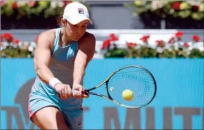  ??  ?? Australian Ashleigh Barty returns the ball to Czech Petra Kvitova during their 2021 WTA Tour Madrid Open match at the Caja Magica in Madrid on Tuesday.