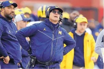  ?? DARRON CUMMINGS/ASSOCIATED PRESS ?? Michigan coach Jim Harbaugh, watching a replay on the video board against Indiana last week, is looking for his first victory against Ohio State since taking over as coach in 2015.