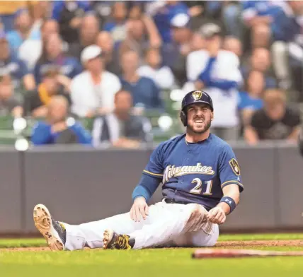  ??  ?? Brewers third baseman Travis Shaw grimaces after being tagged out at home during the fourth inning Wednesday night at Miller Park. Shaw was trying to score from second on Orlando Arcia’s single.