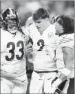  ??  ?? The Steelers’ Trey Edmunds, left, and Jordan Dangerfiel­d, right, stand with quarterbac­k Mason Rudolph after a brawl against the Browns.