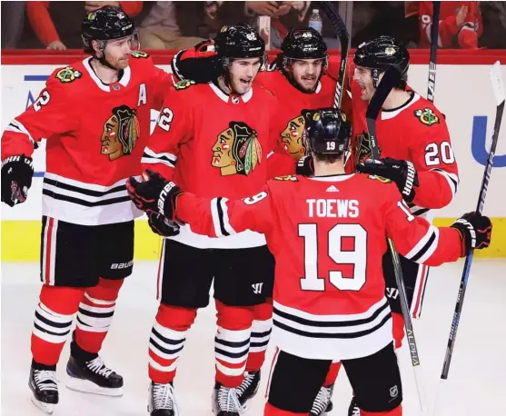  ?? | JONATHAN DANIEL/ GETTY IMAGES ?? Jordan Oesterle ( second from left) celebrates his third- period goal with Duncan Keith, Vinnie Hinostroza, Jonathan Toews and Brandon Saad.