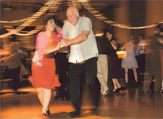  ?? Katie Falkenberg Los Angeles Times ?? DANCE instructor Erin Stevens puts Dan Carper through his paces during swing dance night in Pasadena. Participan­ts say dancing improves mind, body and spirit.