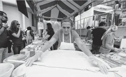  ??  ?? Sevinc Yunus, above, prepares Gozlene Turkish Flat Bread at Sevinc’s Kitchen during the 26th Houston Turkish Festival on Saturday at Jones Plaza, and Nil Dursun, 4, right center, sings with the ATA Houston Children's Choir. Ozlem Adra, the president of ATA, said the festival brings Turkey to Houston residents.