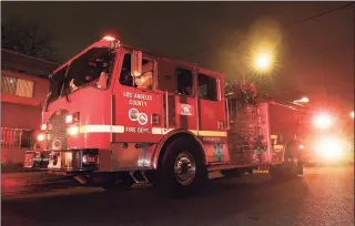  ?? Mark J. Terrill / Associated Press ?? Los Angeles County Fire Department vehicles sit at a medical call Friday in Inglewood, Calif. Occasional­ly, firefighte­rs transport patients to the hospital in fire engines because of short staffing amid an explosion in omicron-fueled coronaviru­s infections at an ambulance company that the fire department contracts with.