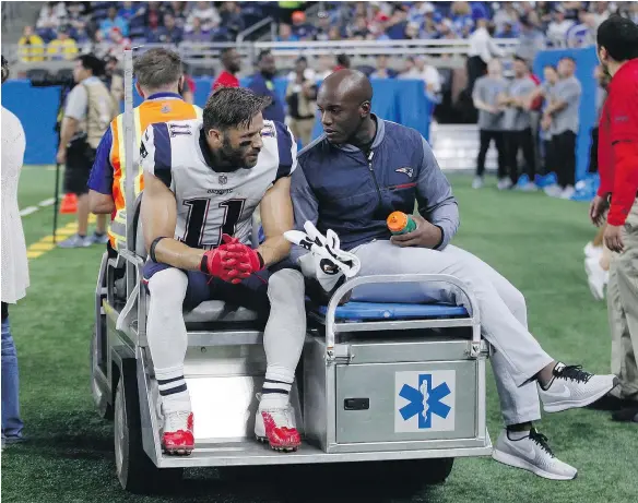  ?? — THE ASSOCIATED PRESS FILES ?? New England Patriots wide receiver Julian Edelman is taken off the field on a cart after tearing his ACL in an NFL pre-season game against the Lions in Detroit on Friday night. The injury will end his season before it even began.