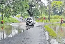  ?? Picture: REPEKA NASIKO ?? LEFT: A four-wheeldrive vehicle drives through a flooded road in Ba.