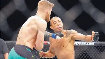  ?? AP FILE ?? Conor McGregor, left, knocked out Jose Aldo in 13 seconds in this 2015 fight. Aldo, who is still asked about the defeat, regained his featherwei­ght title and will put it on the line today against Max Holloway.
