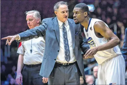  ?? ST. JOHN’S EDGE PHOTO/JEFF PARSONS ?? St. John’s Edge coach Jeff Dunlap goes over a play with newcomer Xavier Ford during a recent game. Dunlap has built the Edge from scratch.