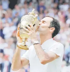  ??  ?? Switzerlan­d’s Roger Federer poses with the trophy as he celebrates winning the final against Croatia’s Marin Cilic, in this July 16, 2017 file photo. — Reuters photo