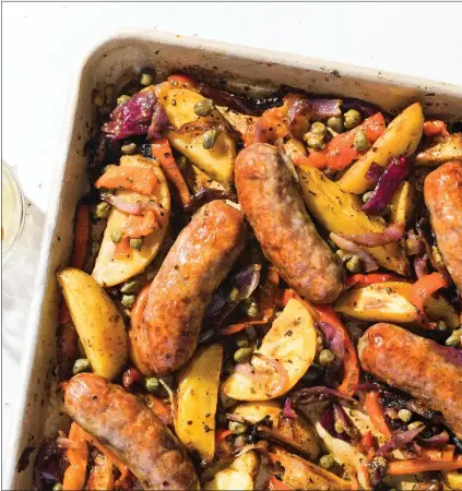  ?? MILK STREET VIA AP ?? This image released by Milk Street shows a recipe for sausage and potato traybake.