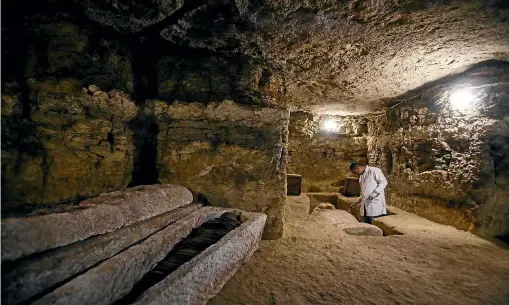  ?? GETTY IMAGES ?? An archaeolog­ist works inside a communal tomb, one of the newly discovered tombs of the high priests of ancient Egyptian deity Djehuty (Thoth) and senior officials in the fifteenth nome (territoria­l division) of Upper Egypt and its capital, Ashmunin, at the Al-Ghoreifa area in Tuna El-Gabal archaeolog­ical site.