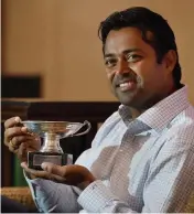  ?? — PTI ?? Leander Paes poses with the French Open mixed doubles trophy in New Delhi on Tuesday.