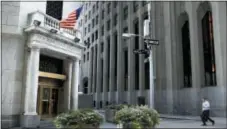  ?? SETH WENIG — THE ASSOCIATED PRESS FILE ?? A man walks toward the New York Stock Exchange.