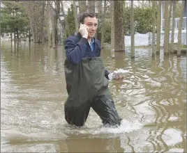  ?? CP PHOTO ?? A man makes his way through the flooded streets in Laval, Que., on May 10. Even as swollen rivers have receded in Quebec, some experts suggest historic flooding this year could mean critter and pest-related woes in months and years to come.