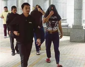  ?? BY MOHD FADLI HAMZAH PIC ?? The suspects at the magistrate’s court in Putrajaya yesterday.