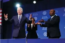  ?? AP PHOTO/PATRICK SEMANSKY ?? President Joe Biden and Vice President Kamala Harris stand on stage Friday with DNC Chairman Jaime Harrison at the Democratic National Committee winter meeting in Philadelph­ia.