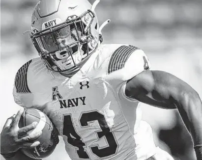  ?? JACOB KUPFERMAN/AP ?? Senior fullback Nelson Smith, above, and running mate Jamale Carothers have carried the load for the Navy offense so far this season. Fullback runs account for 70 % of the team’s rushing yardage.