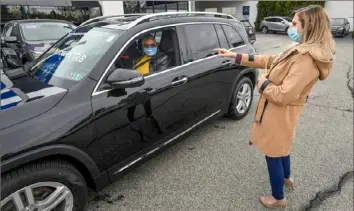  ?? Christophe­r Millette/Erie Times-News via AP ?? Customer Sabra Jefferson, left, listens as sales representa­tive Holly Wurst explains the dashboard controls on Friday at Contempora­ry Motorcar in Millcreek, Erie County.