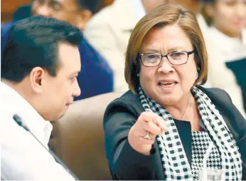  ?? (AP FOTO) ?? SENATE PROBE. Sen. Leila de Lima talking to Sen. Antonio Trillanes IV in this file photo during the continuing Senate probe on the rising number of extrajudic­ial killings related to President Rodrigo Duterte’s “war on drugs.” Senators, led by de Lima,...