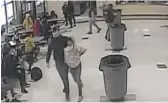  ?? KENOSHA UNIFIED SCHOOL DISTRICT VIA AP ?? An off-duty police officer escorts a 12-year-old student out of a school cafeteria after a fight in Kenosha, Wis., on March 4.