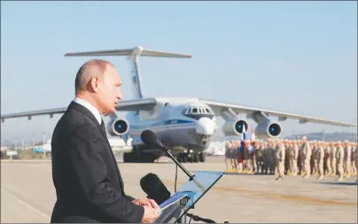  ?? AP PHOTO ?? In this file photo taken last December, Russian President Vladimir Putin addresses the troops at the Hemeimeem air base in Syria. Several private Russian military contractor­s were killed by a U.S. strike in Syria, Russian media reported Tuesday.