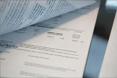  ?? Emily Matthews/Post-Gazette photos ?? Documents and notes, including bank statements that go back to 2011 and a letter from PNC Bank stating the discontinu­ation of their life insurance policy, are laid out across Jeffrey and Jean Krieger’s table in their Banksville home.