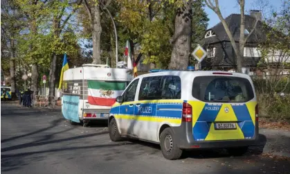  ?? Photograph: Christophe Gateau/AP ?? Three men with face coverings reportedly tore down flags and banners from a caravan parked near the Iranian embassy in Dahlem.