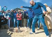  ?? PAUL W. GILLESPIE/CAPITAL GAZETTE ?? Gov. Wes Moore throws his socks into the fire at the 11th annual Annapolis Oyster Roast and Sock Burning held on March 18 at the Annapolis Maritime Museum.