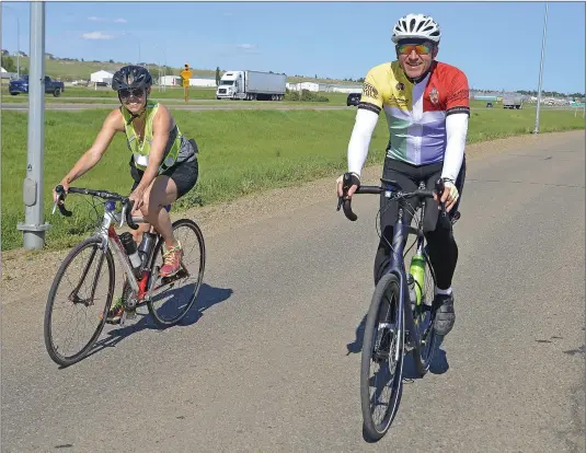  ?? SCOTT ANDERSON/SOUTHWEST BOOSTER ?? Bishop Robert Hardwick was joined by Eston’s Shannon Elaschuk for the 136 kilometre long Maple Creek to Swift Current portion of his cross Canada cycling pilgrimage.