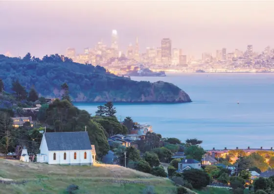  ?? Shuttersto­ck ?? San Francisco Bay and the city’s skyline are seen in the background of this photo, which includes Old St. Hilary’s Historic Preserve in Tiburon.